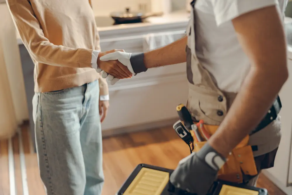 plumber shaking womans hand